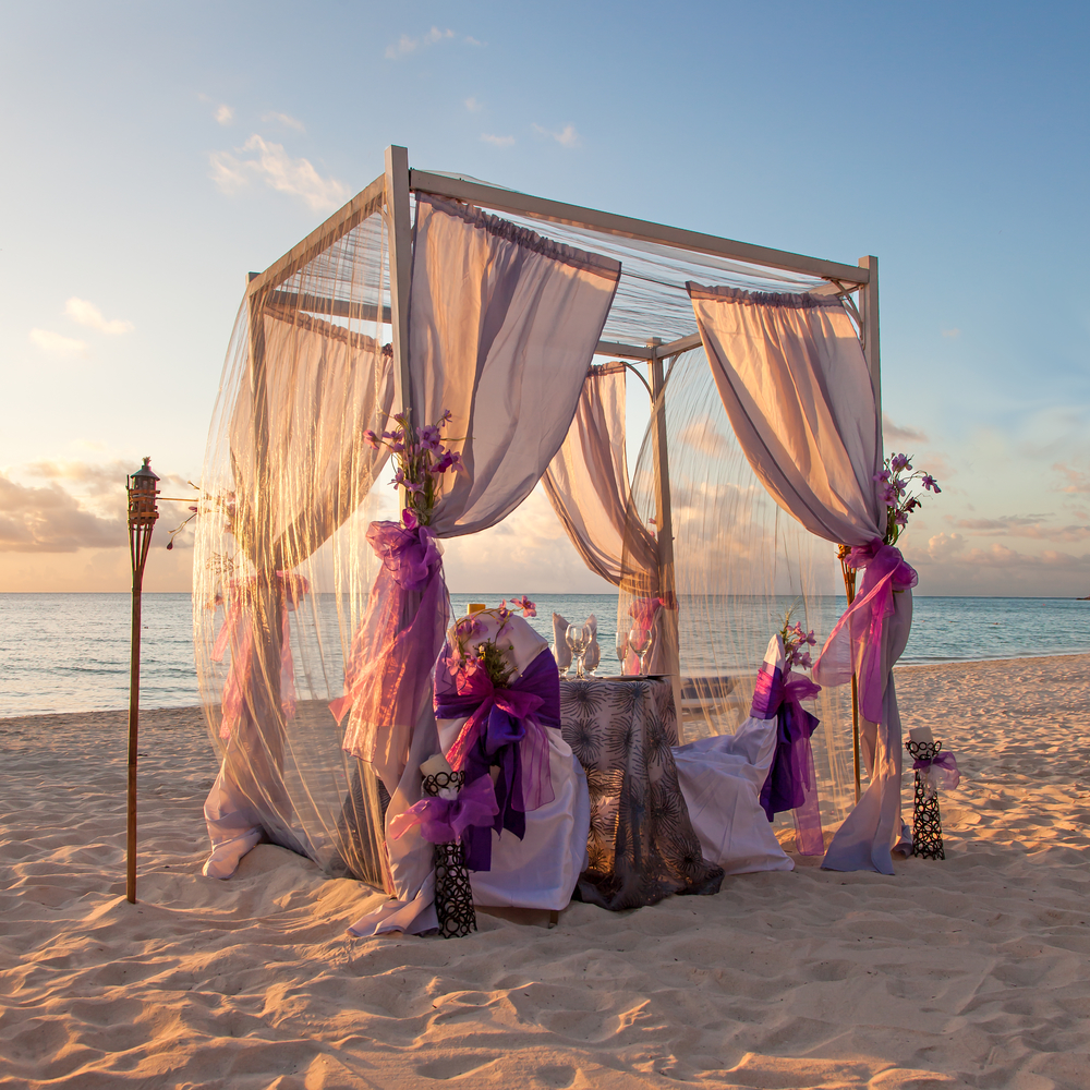Romantic Wedding Table on Sandy Tropical Caribbean Beach at Sunset